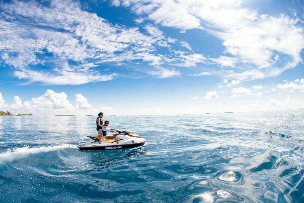 Enjoy a thrilling jet ski ride in the serene waters of Kaafu Atoll, Maldives.